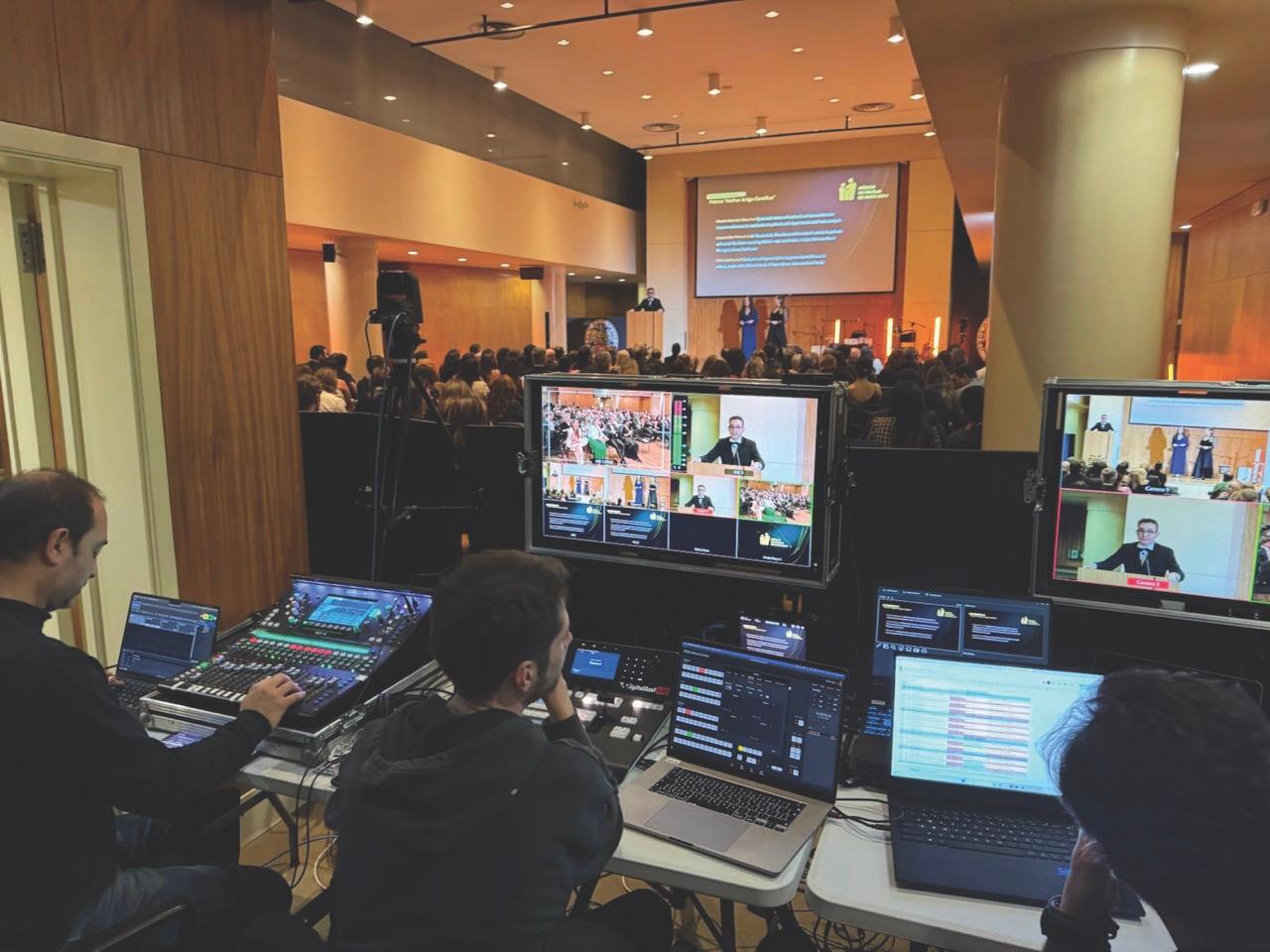 A mixing room with a window looking into a conference hall