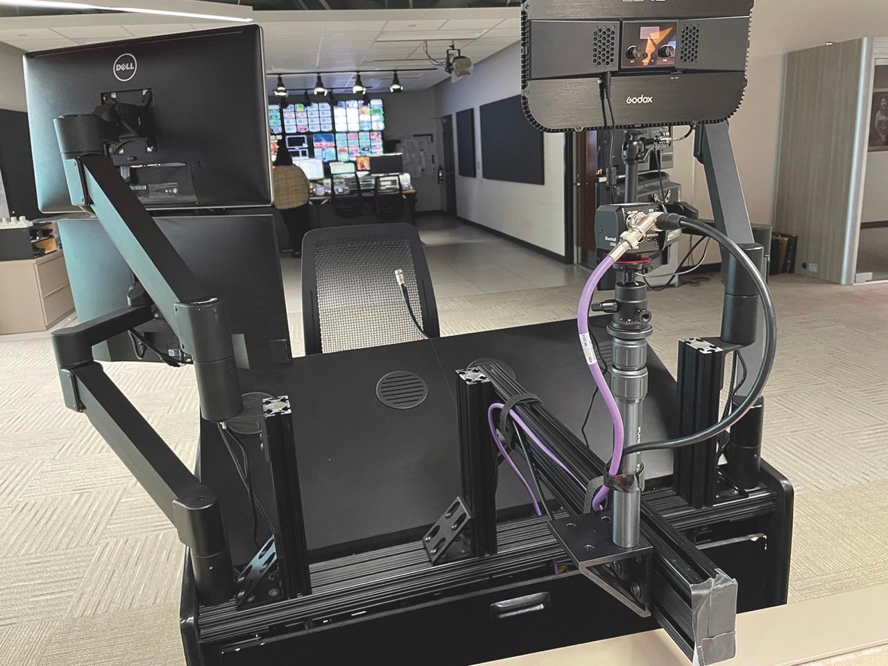 The back of black device at a desk in a newsroom