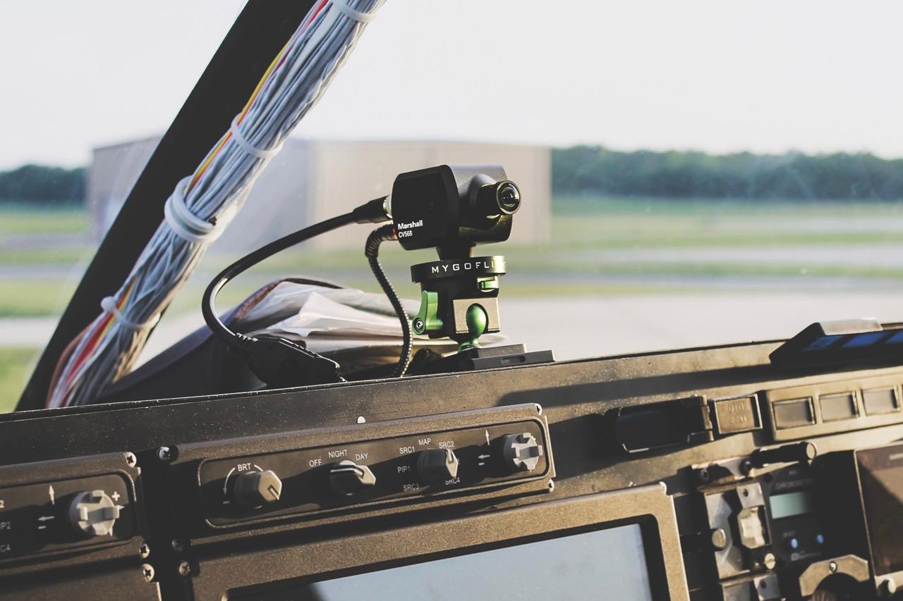 A small camera mounted on the dashboard of a car