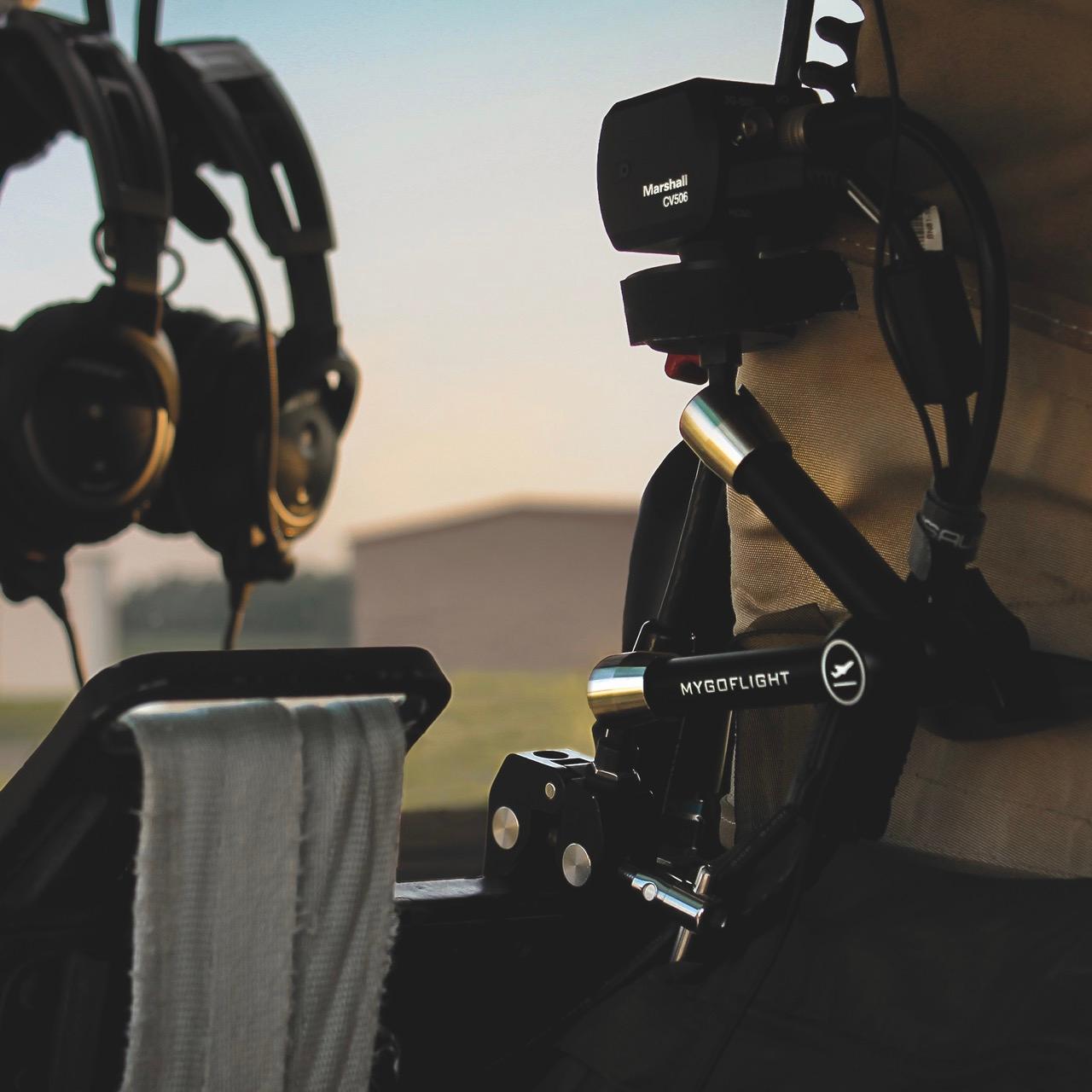 A device from Marshall with headphones hanging nearby. The setting is outside