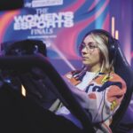 A woman wearing headphones and sitting in a gaming chair playing esports