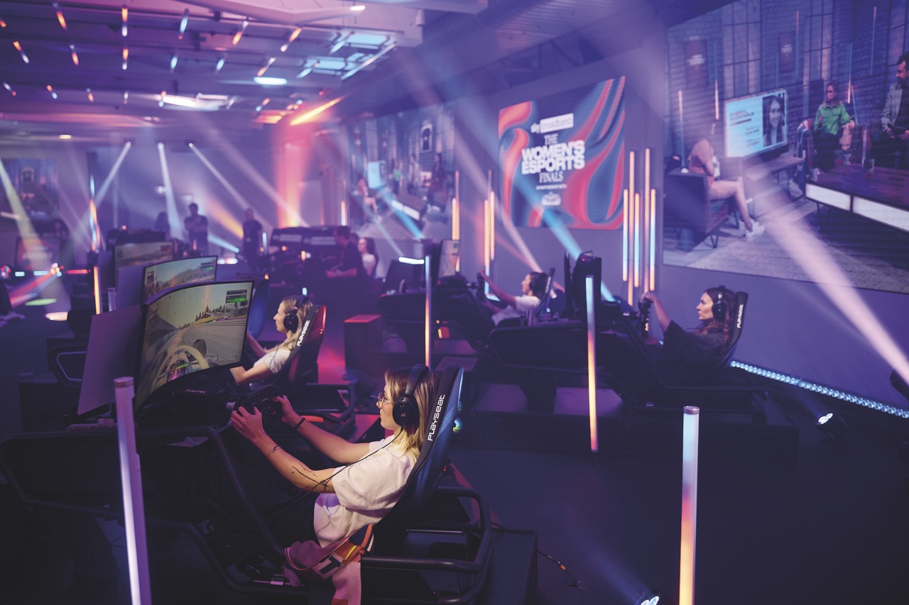 Rows of women sitting at gaming chairs playing esports